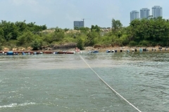 Use-boat-to-pull-out-silt-curtain-from-shore-2